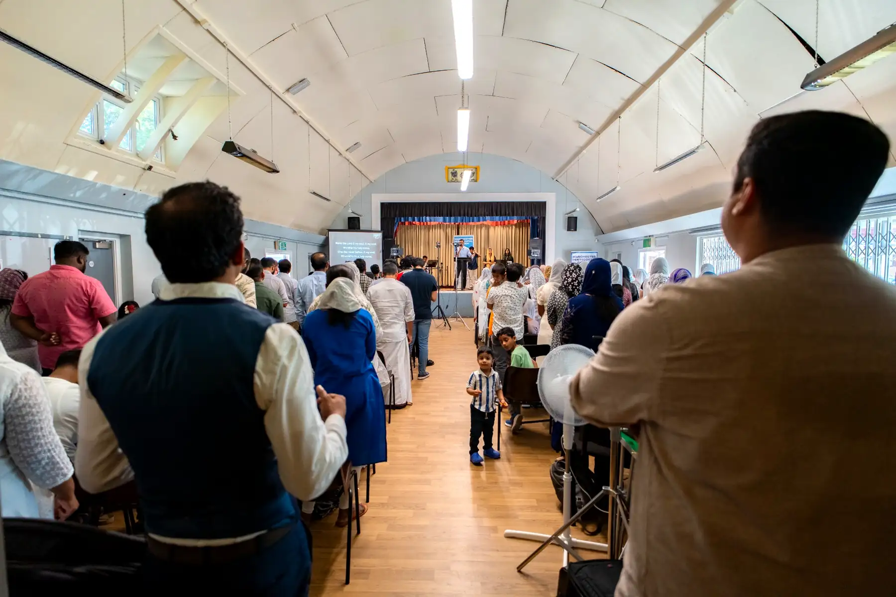 The Malayalam congregation gathered in worship, seen from behind