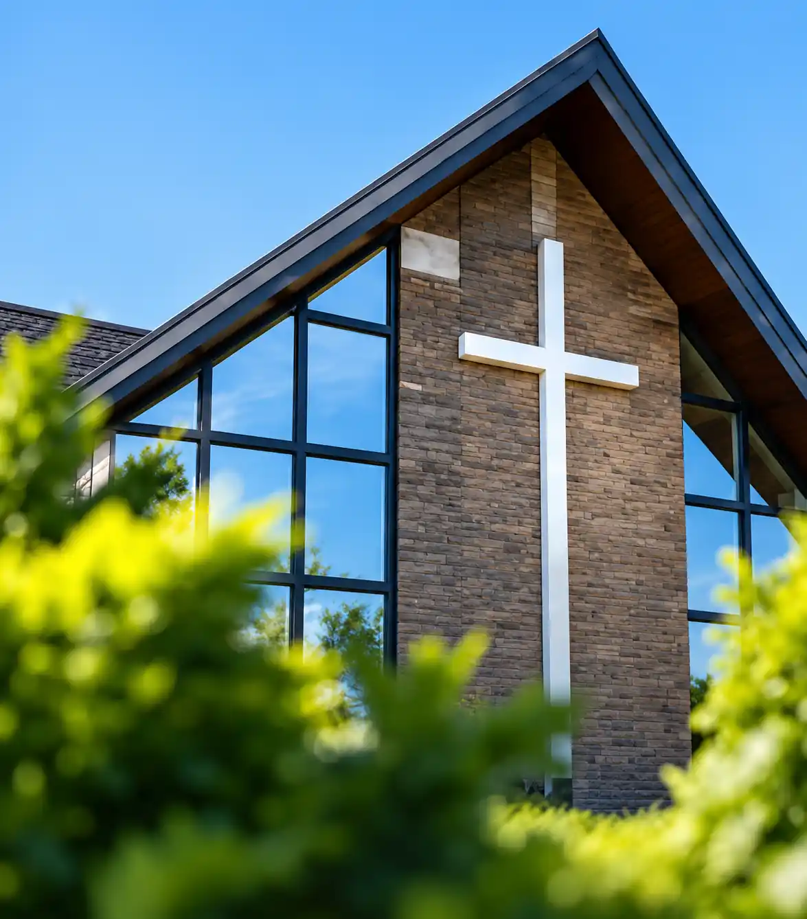 The exterior of Manchester Pentecostal Church with a cross above its entrance